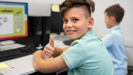 smiling boy with computer screen.jpg